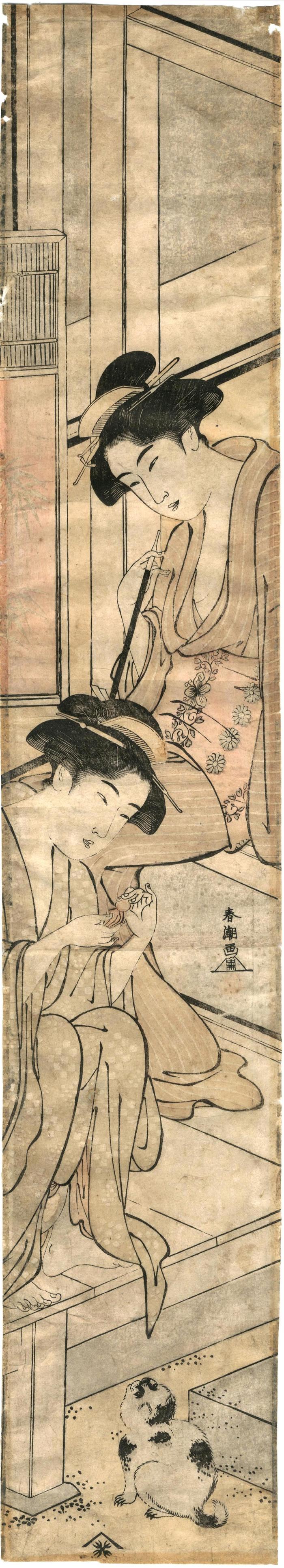 Two girls relaxing with a dog 